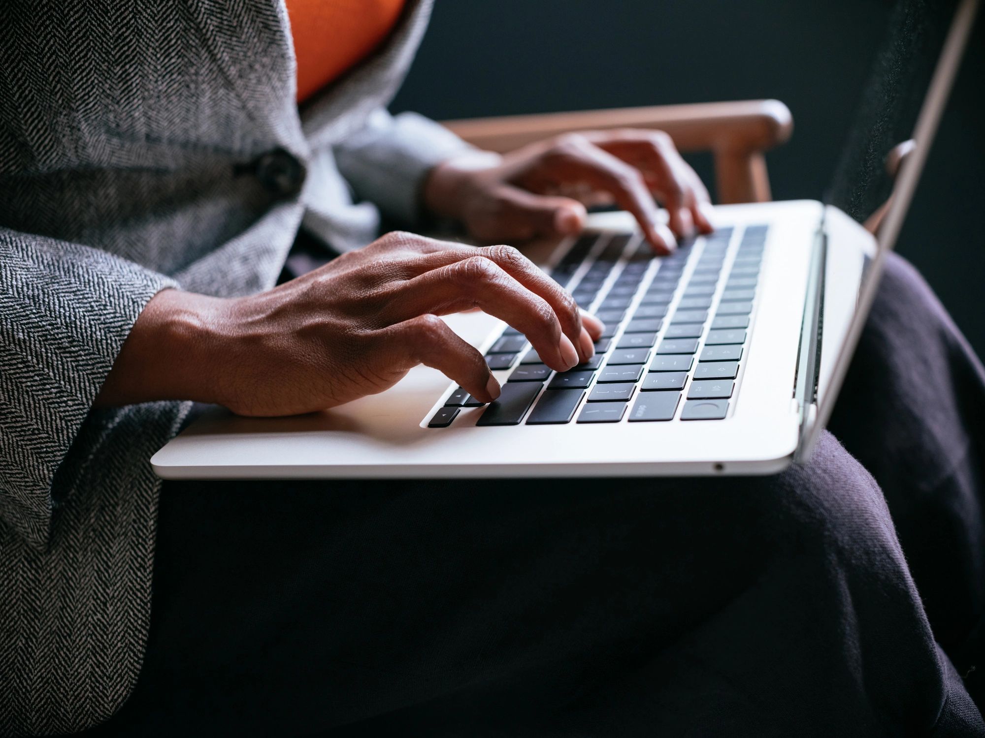Professional working on a laptop for a remote legal proceeding
